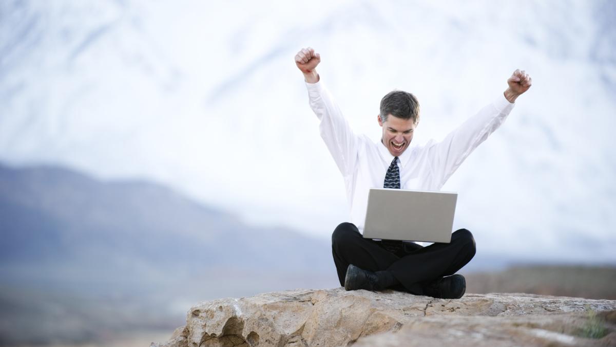 istock_12573288lg_happy_man_laptop_rock_19883300