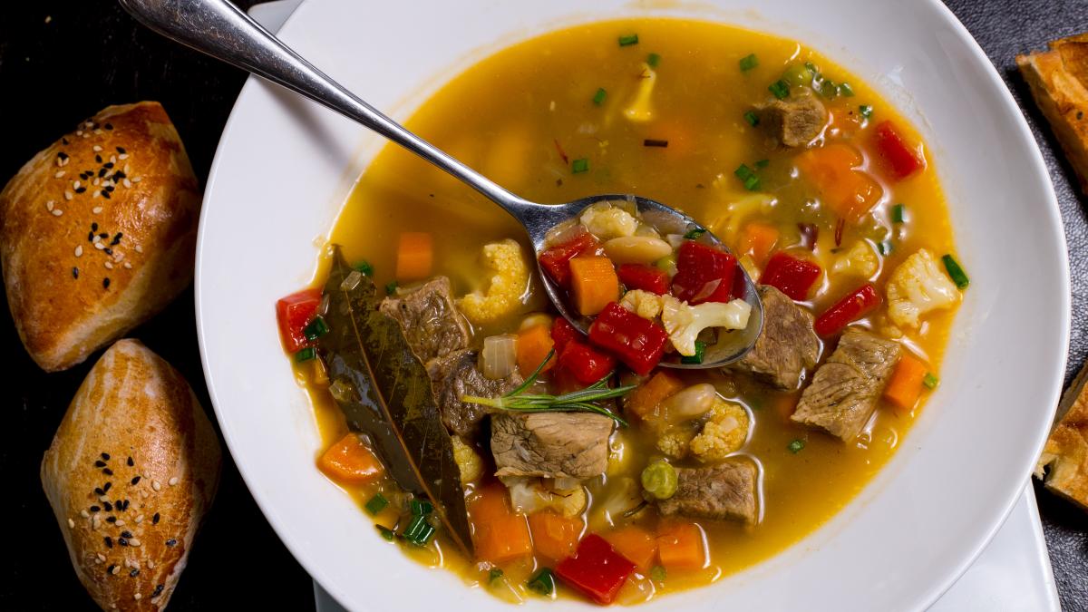 spoon-plate-beans-soup-meat-carrot-potato-tomato-greens-top-view_76101200