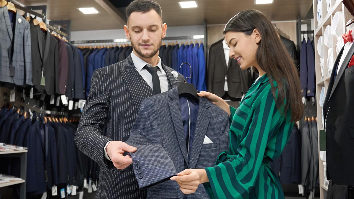 client-shop-consultant-looking-trying-jacket_23169800