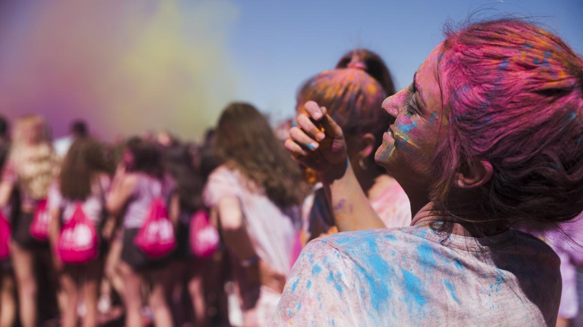 rear-view-young-woman-playing-with-holi-powder_60722400