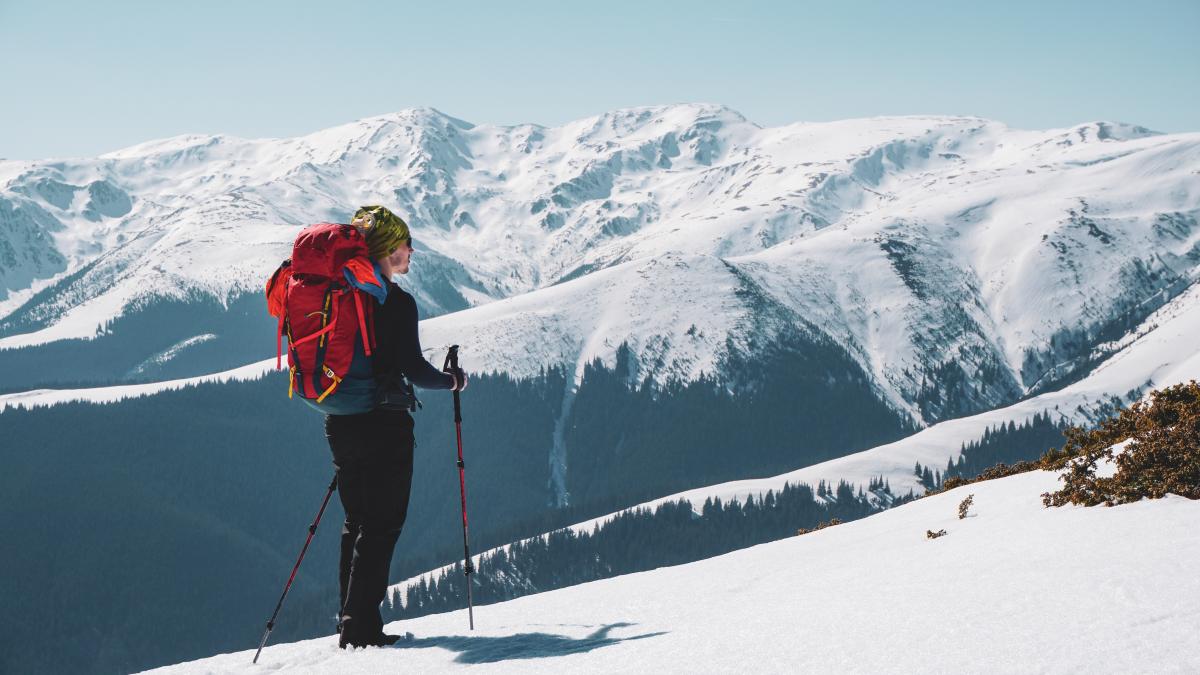 male-mountain-climber-enjoying-snow-covered-mountain-view-from-summit_24716400