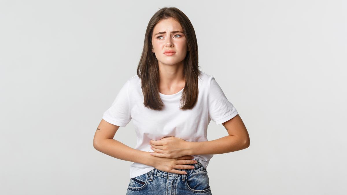 woman-having-stomach-ache-bending-with-hands-belly-discomfort-from-menstrual-cramps_87235000