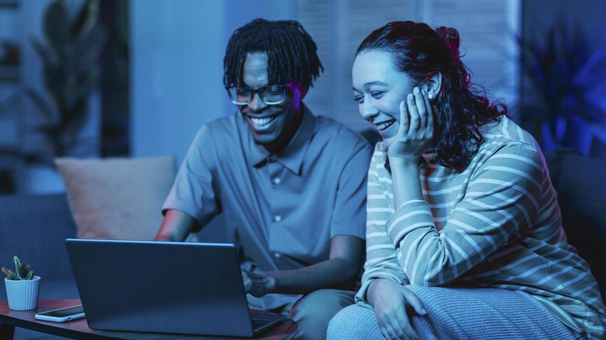 couple-using-laptop-while-couch-home-together_34835700