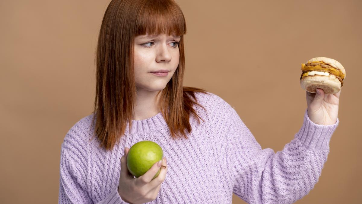 woman-with-eating-disorder-deciding-which-food-eat_62152500
