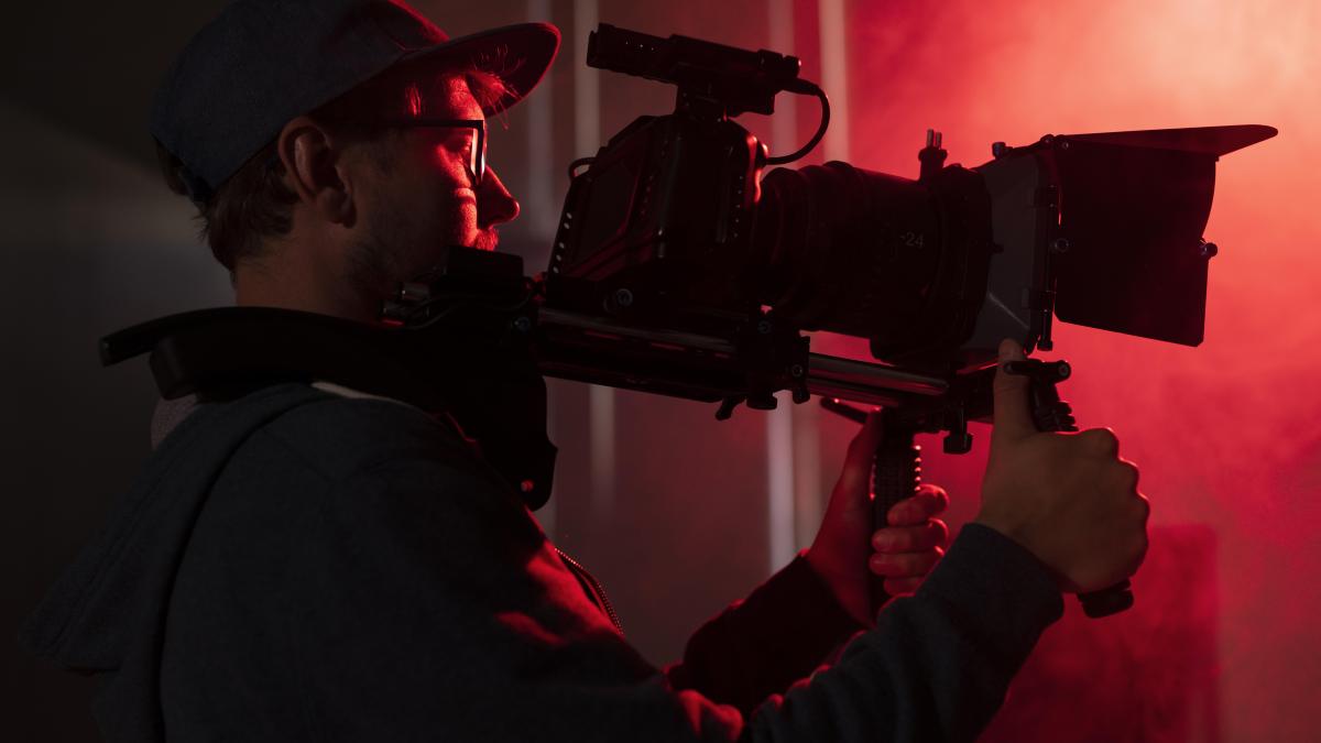 man-filming-with-professional-camera_98301500