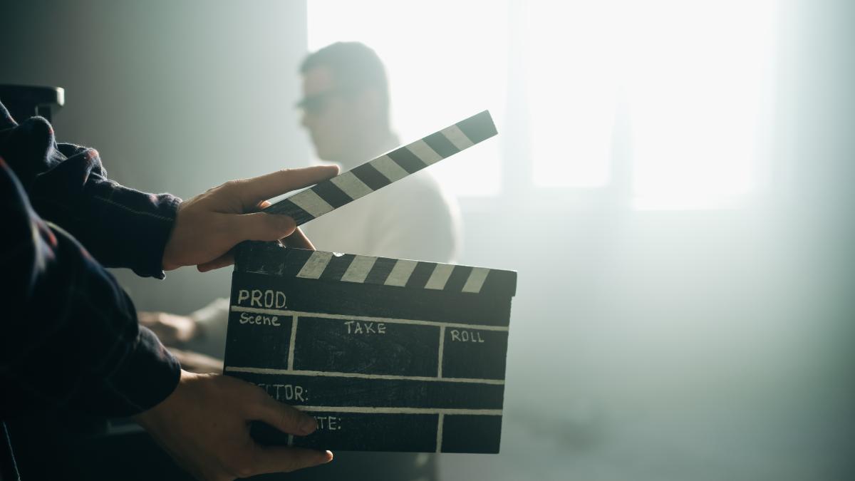 clapperboard-clipboard-hands-guy-is-directing-filming-retro-cinema-vintage-movie-composer-man-play-old-piano_01223900