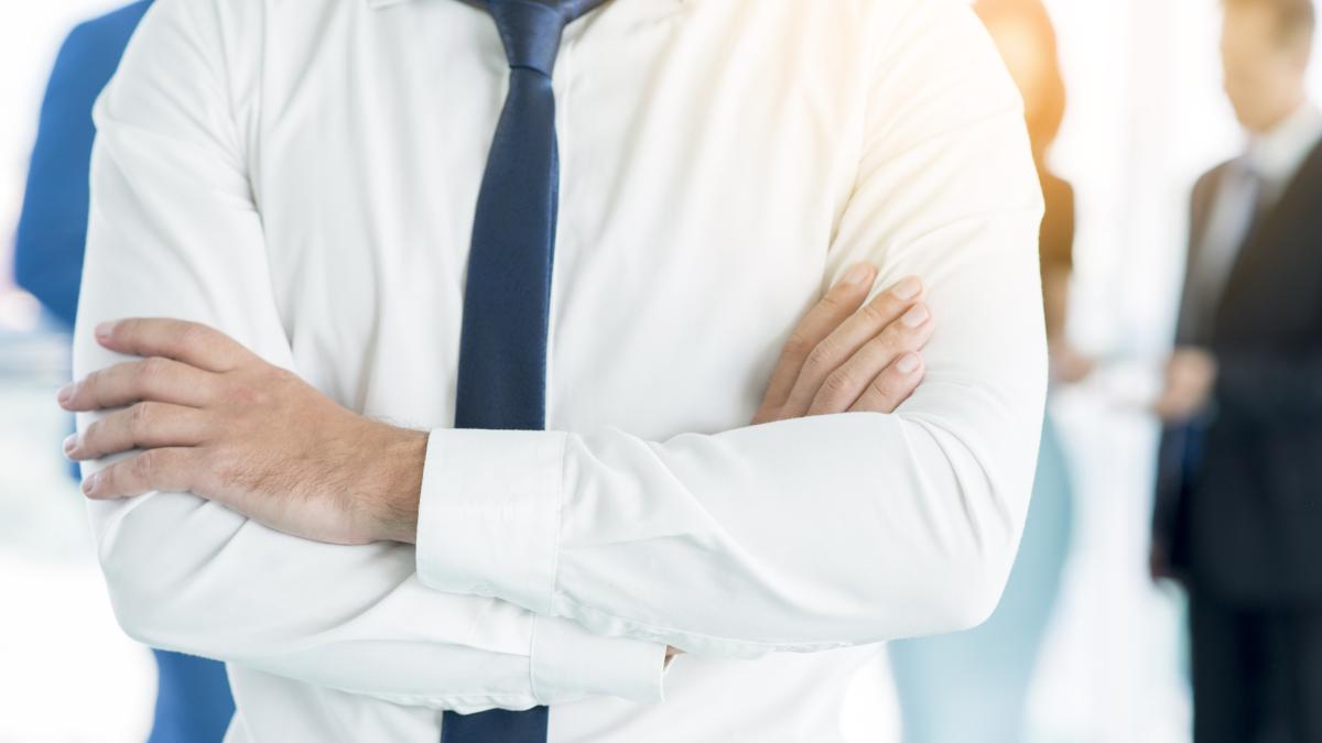 close-up-businessman-s-folded-arms_64278100
