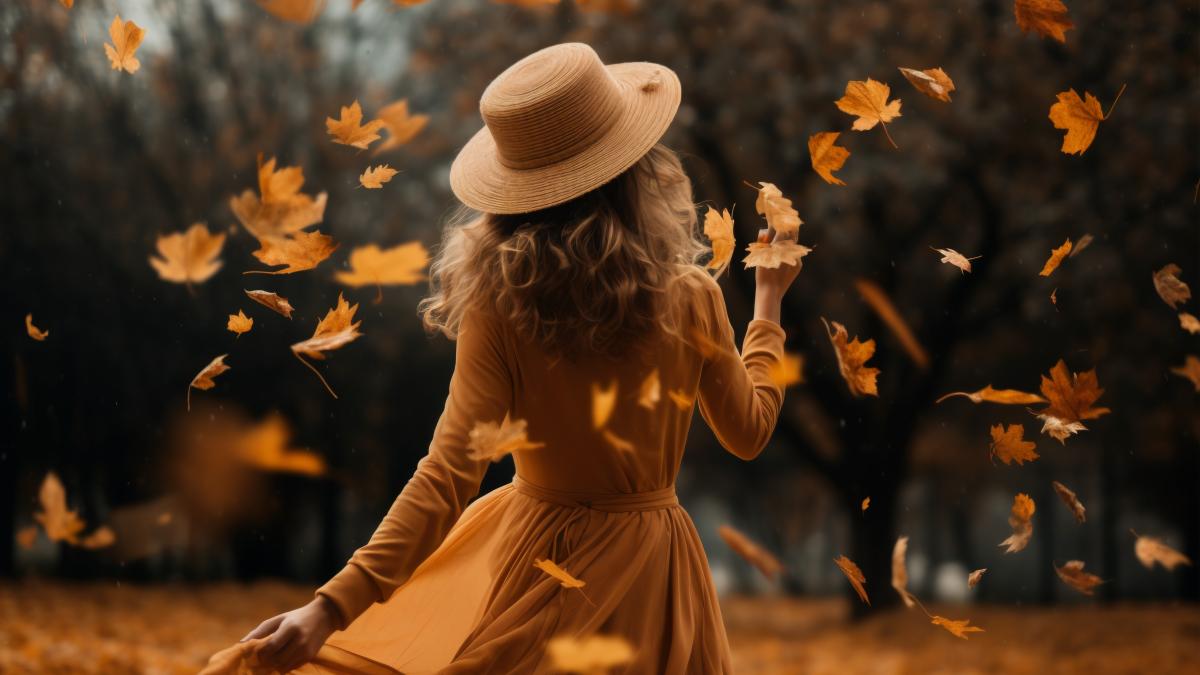 back-view-woman-with-dry-autumn-leaves_23820600