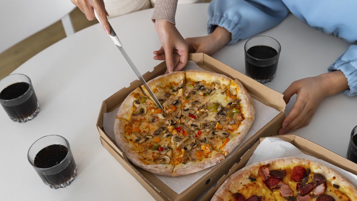 group-friends-eating-pizza-home-together_79600900