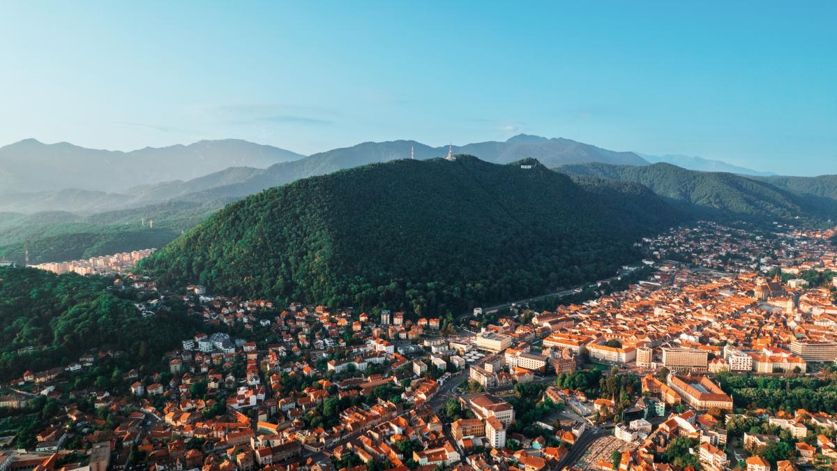 aerial-drone-view-brasov-romania-old-city-centre-with-old-buildings-hills-covered-with-greenery_12774100_35913600