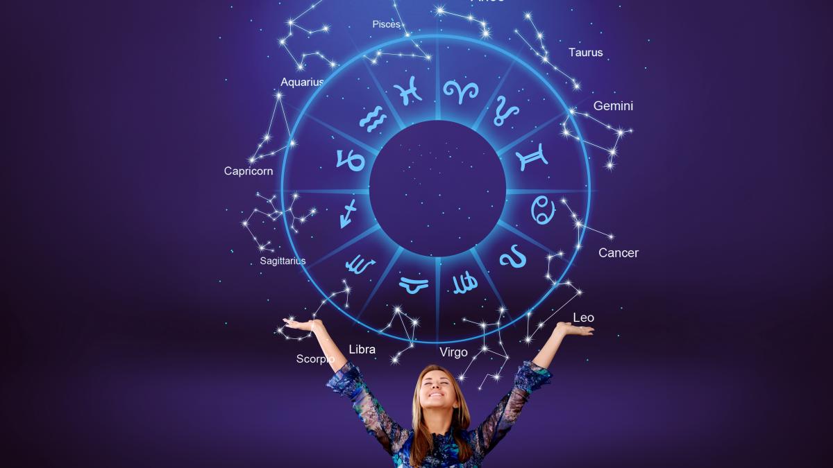 woman-raising-hands-looking-night-sky-astrological-wheel-projection_52271100