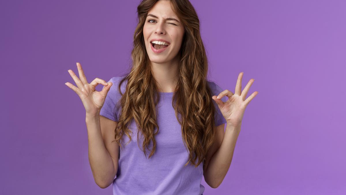 got-it-relax-everything-perfect-relaxed-carefree-curly-girl-winking-cheeky-smiling-cunning-show-okay-ok-ring-sign-assure-all-good-stand-satisfied-accepting-great-choice-approving-purple-background_07056700
