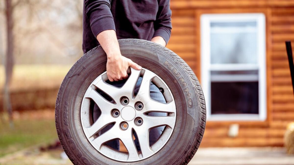 male-carrying-new-car-tire_181624-45046_91804600