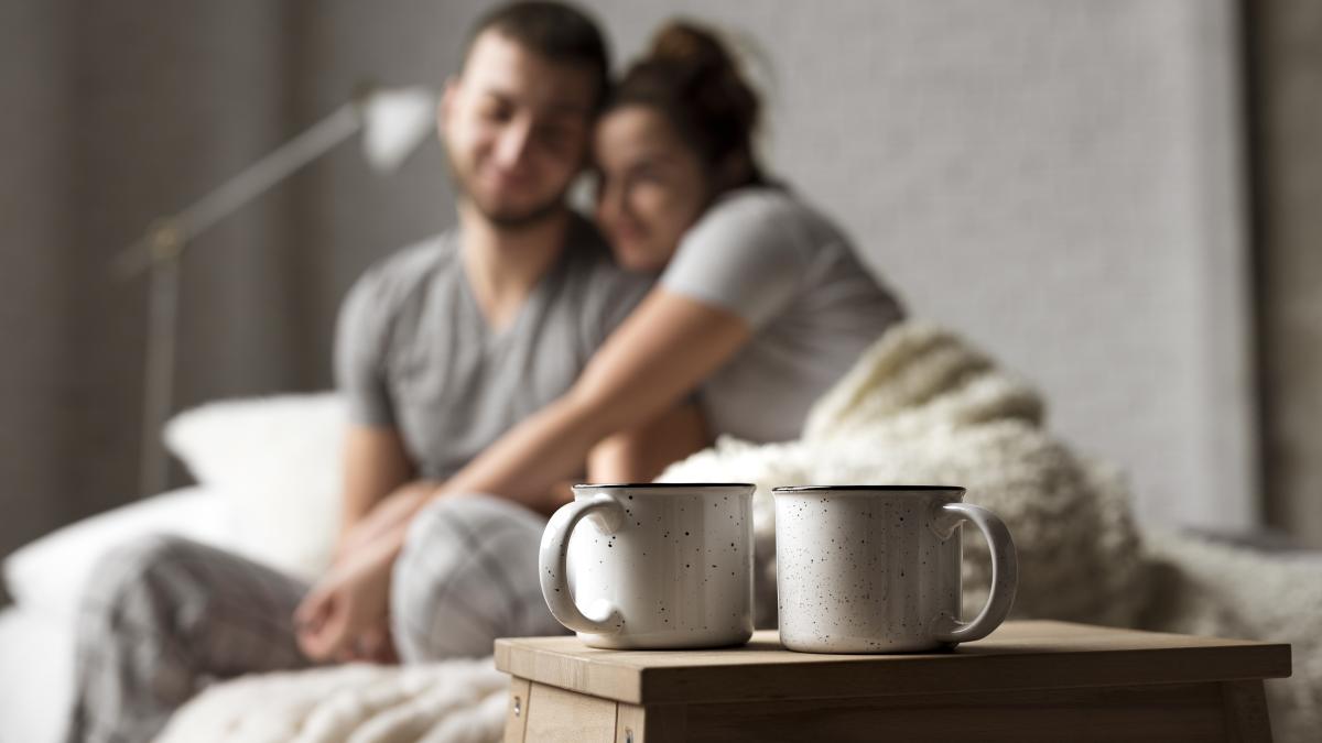 coffee-cups-table-with-young-couple_79693200