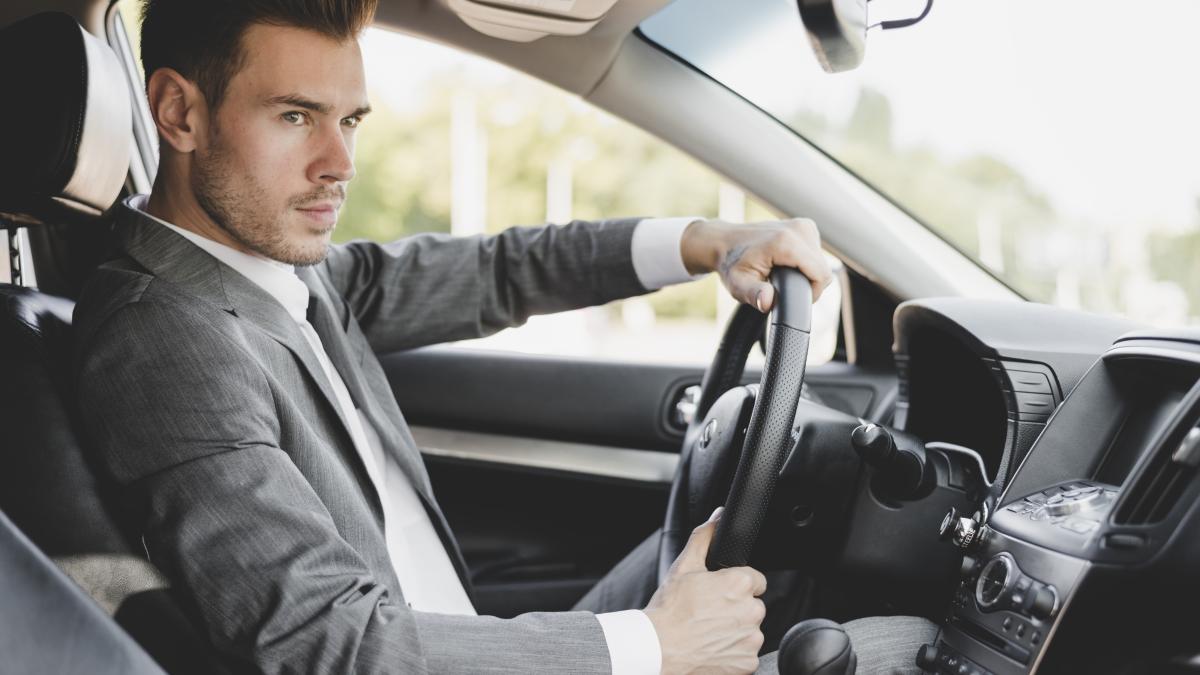 stylish-young-businessman-driving-car_62124600