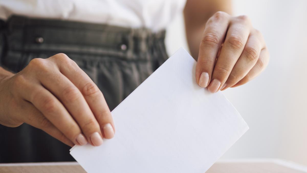 woman-placing-ballot-box_43017500