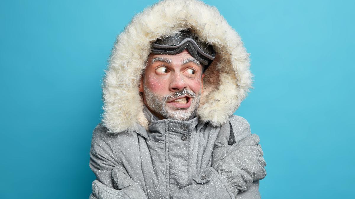 photo-european-man-trembles-from-cold-after-going-skateboarding-crosses-hands-body-tries-warm-himself-wears-grey-winter-jacker-with-fur-hood-gloves-has-frozen-face-covered-by-ice_63373100
