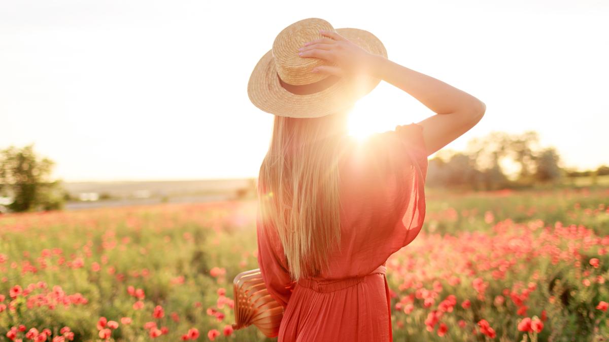 photo-from-back-inspired-young-woman-holding-straw-hat-looking-horizon-freedom-concept-warm-sunset-colors-poppy-field_37079100