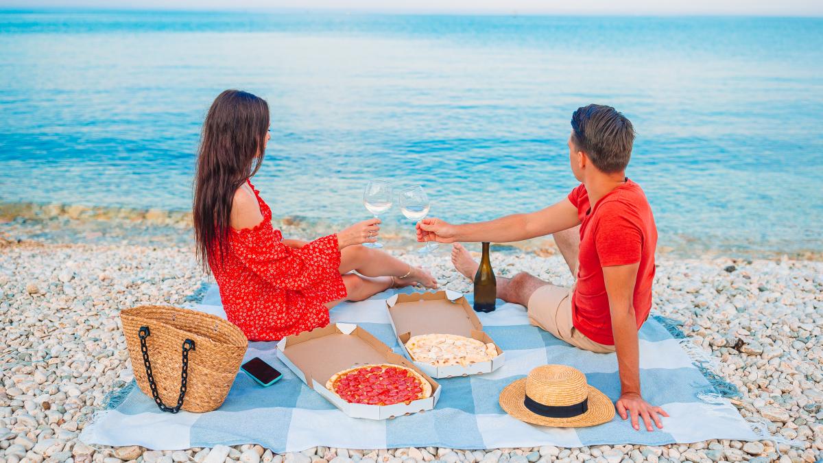 rear-view-people-sitting-beach_29656200