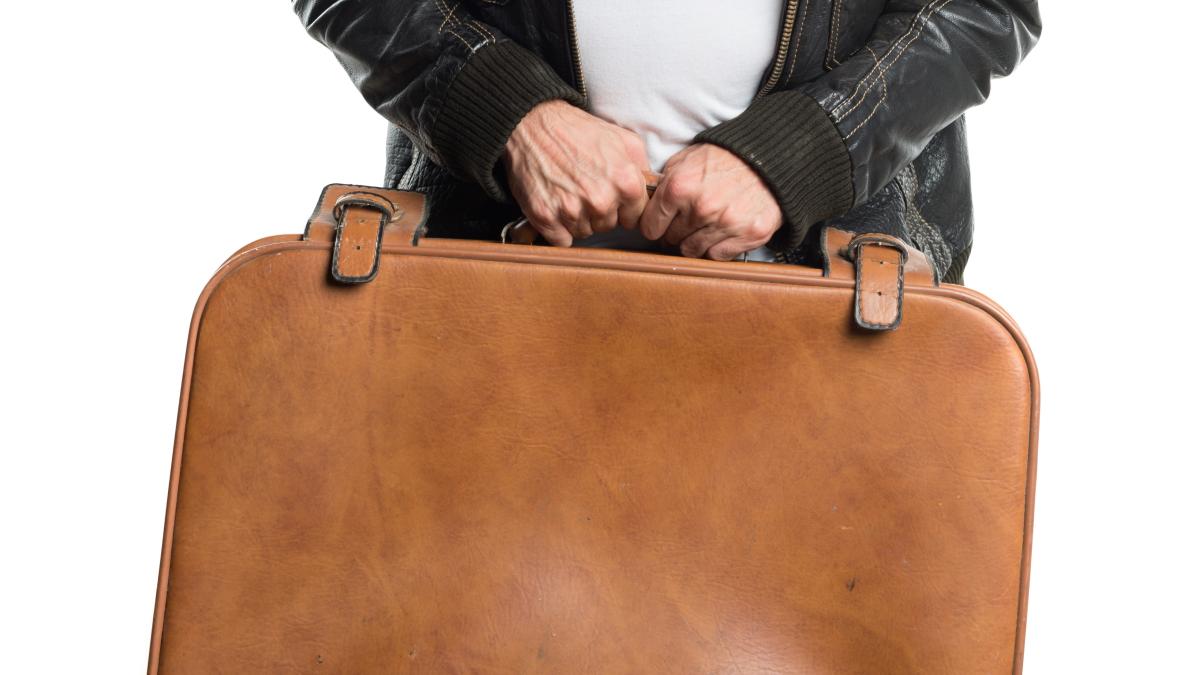 man-wearing-leather-jacket-holding-suitcase_97988800