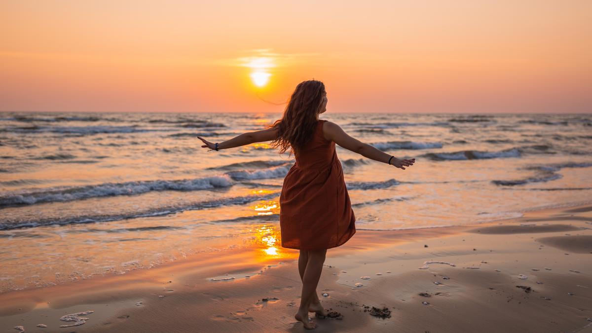 beautiful-shot-model-wearing-brown-sundress-enjoying-sunset-beach-1_87442800