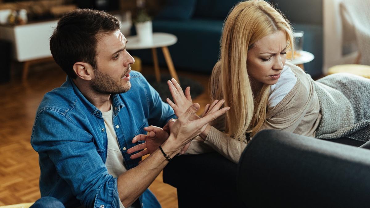 couple-with-relationship-difficulties-having-conflict-while-talking-living-room