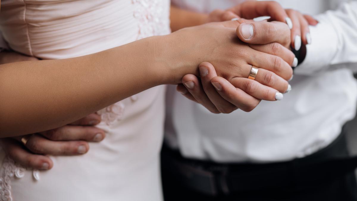 man-holds-woman-s-hand-tender-his-strong-arm