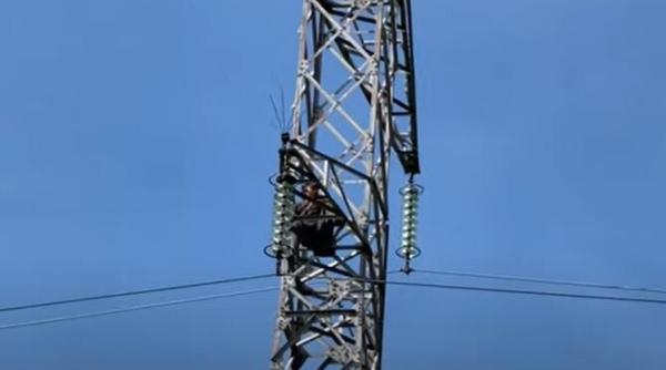 un barbat s a urcat pe un stalp de inalta tensiune si a amenintat ca se arunca video